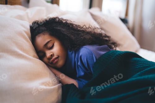 Preview: Smiling cute little girl sleeping over cozy bed in bedroom