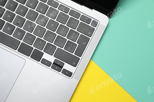Preview: Modern laptop with keyboard on color background, top view. Space for text