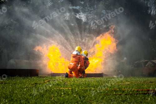Preview: Firefighter Concept. Fireman using water and extinguisher to fighting with fire flame.