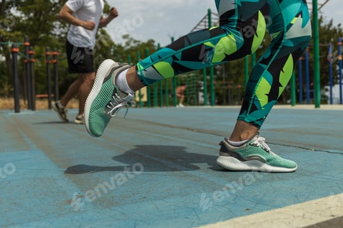 Preview: Girl's legs in sports shoes and leggings, close-up