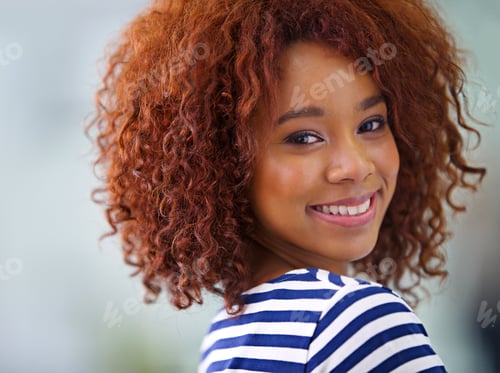 Preview: Closeup portrait of a young African American businesswoman smiling confidently at the camera