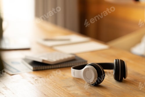Preview: Headphones on wooden desk table. Music concept with copy space.