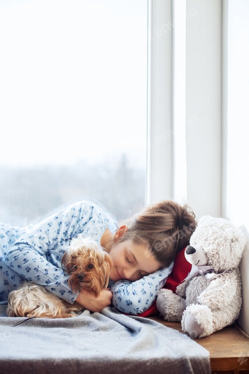 Preview: Happy girl sleeping on window sills. The concept of Christmas.