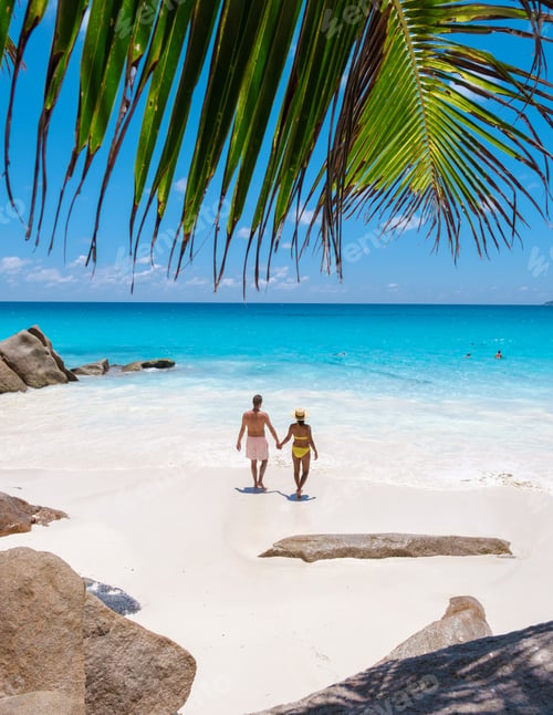 Preview: Anse Lazio Praslin Seychelles, a young couple of men and women on a tropical beach during vacation