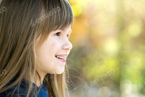 Preview: Portrait of pretty child girl with gray eyes and long fair hair smiling outdoors