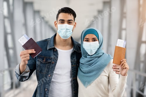 Preview: Portrait Of Muslim Couple In Masks With Passports And Tickets In Airport