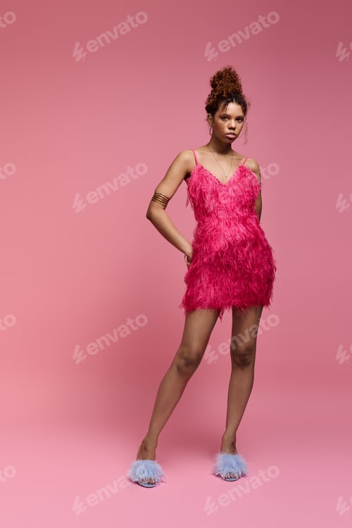 Preview: Stylish young woman in vibrant pink attire stands confidently against a soft pink backdrop