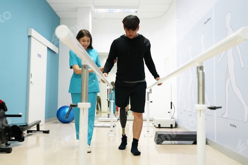 Preview: Nurse helping man walk with prosthetic leg.