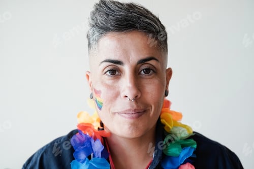 Preview: Gay lesbian woman having fun at LGBT pride event - Nonbinary person looking at camera