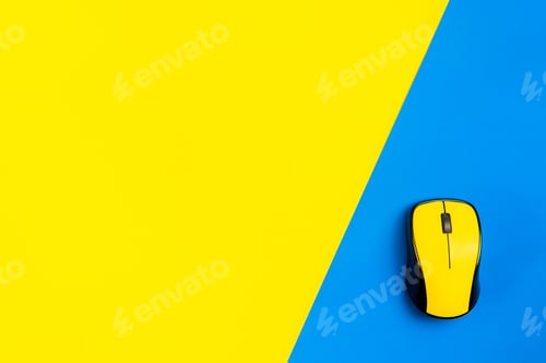 Preview: flat lay workspace yellow computer mouse, yellow and blue background.