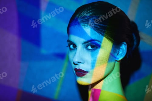 Preview: A beautiful model in the studio covered with a myriad of abstract lighting