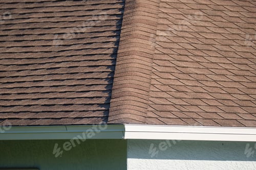 Preview: Closeup of house roof top covered with asphalt or bitumen shingles. Waterproofing of new building