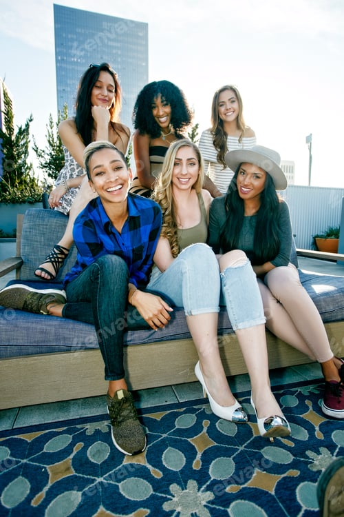 Preview: A group of young women partying on a city rooftop at dusk