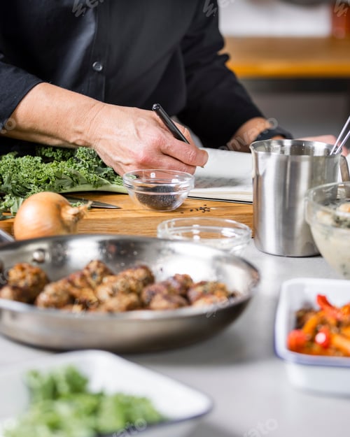 Preview: a man standing in front of a counter top covered in food