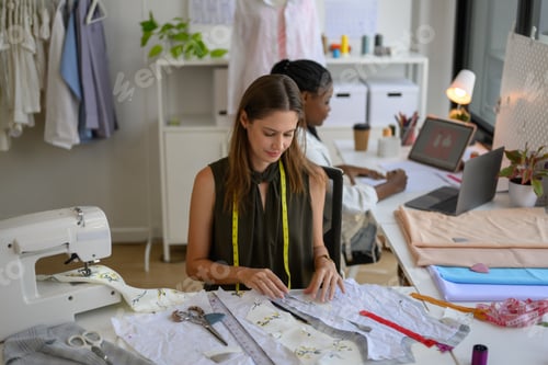 Preview: Happy Couple of fashion designer working together in workshop studio