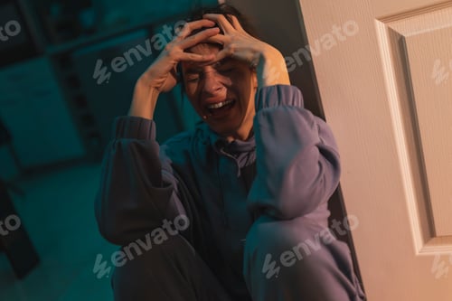 Preview: Sad woman sobbing in the dark