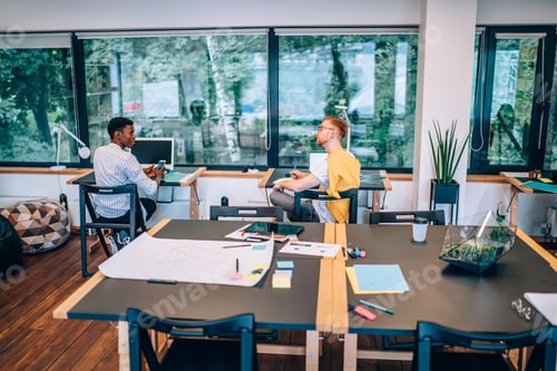 Preview: Diverse male colleagues talking during work