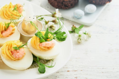 Preview: Stuffed or deviled eggs yolk, shrimp, pea microgreens with paprika for easter table decorate fresh c