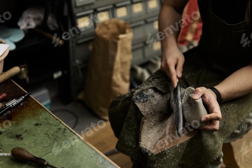 Preview: A shoemaker shaves a mold of a shoe in his workshop