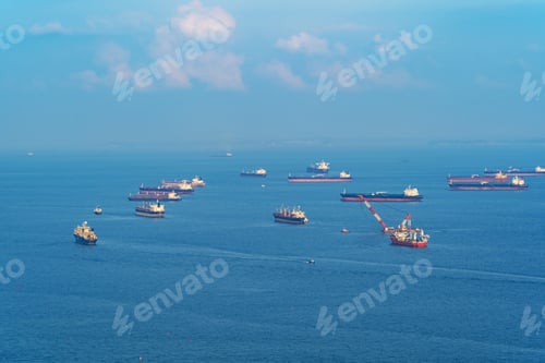 Preview: Cargo tanker ships in transportation concept. Shipping boats at Singapore harbor. Clear blue sea.