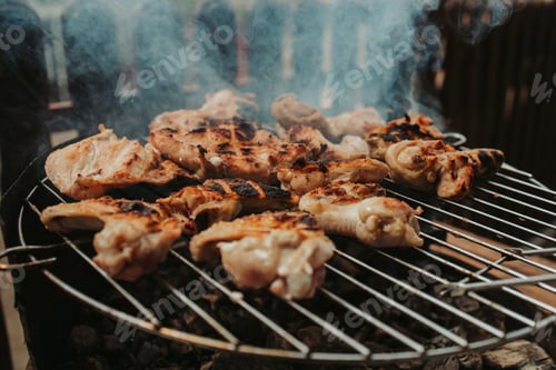 Preview: Closeup shot of sausages and meat preparing in the grill