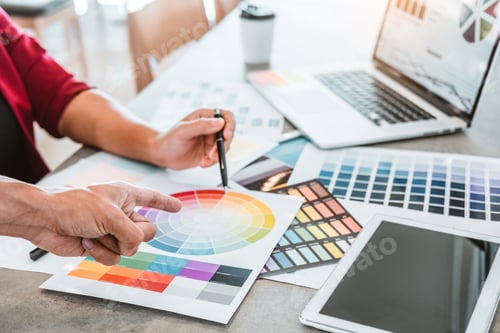 Preview: Two Graphic designer Brainstorming Meeting and drawing on graphics tablet at workplace