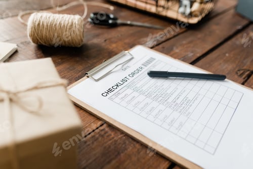 Preview: Clipboard with document and pen, spool of threads, packed box and other items