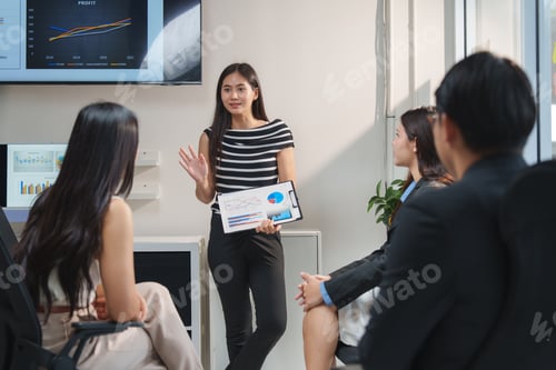Preview: Asian businesswoman leading meeting with charts and graphs
