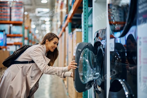 Preview: Young happy buying new drying machine at the store.