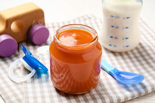 Preview: Healthy baby food in jar on table, closeup