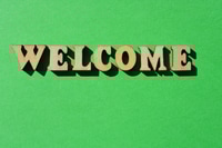Preview: Welcome Message on Green Background with Wooden Letters