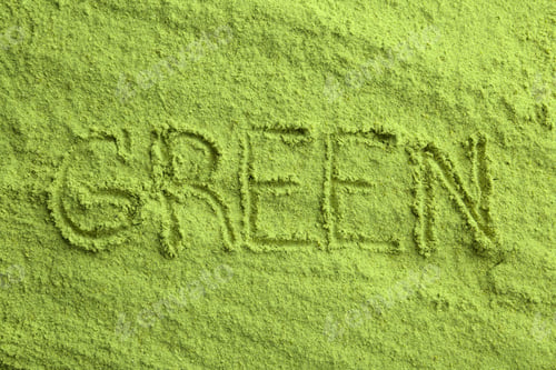 Preview: Word GREEN written on wheat grass powder, top view