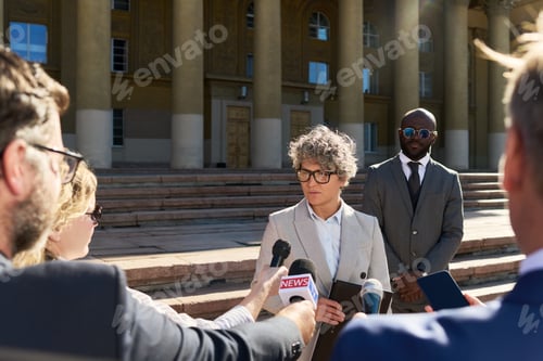 Preview: Middle Aged Caucasian Woman Speaking at Press Conference Surrounded by Reporters