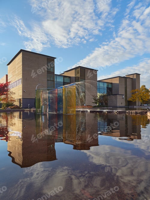 Preview: Public park in Europe and reflection of the city and clouds in the water.