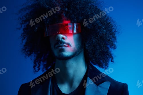 Preview: Fashion portrait of a man with curly hair on a blue background wearing red sunglasses, multinational