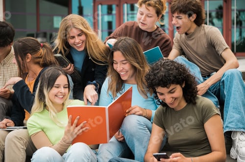 Preview: Delighted multiracial students reading notes and smiling on stairs