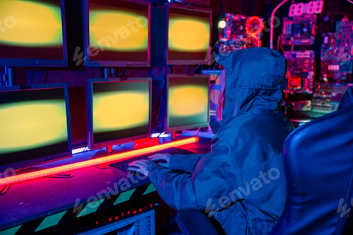 Preview: Woman hacker wear hood sit front computer typing on keyboard hacking servers in neon light, Gamer