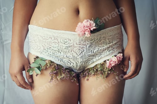 Preview: High angle shot of an unidentifiable young woman with flowers growing out of her lace panties