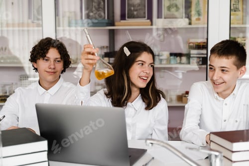 Preview: Happy classmates hold liquid flasks during chemistry laboratory lesson
