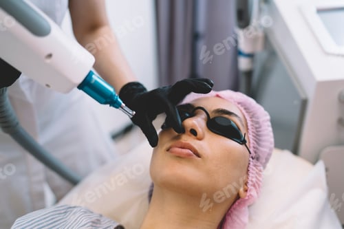 Preview: Woman with closed eyes getting beauty procedure