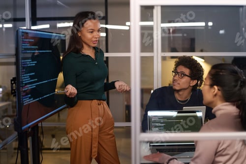 Preview: Young Coworkers Having Meeting In Evening