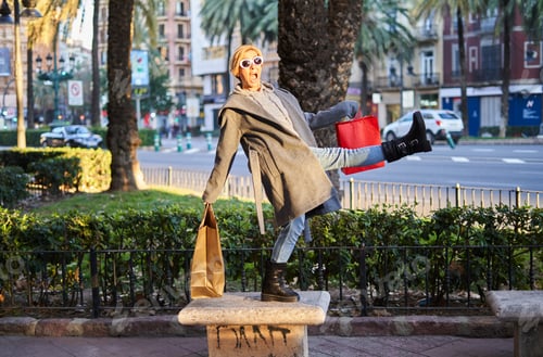 Preview: A young Caucasian girl shows raised shopping bags