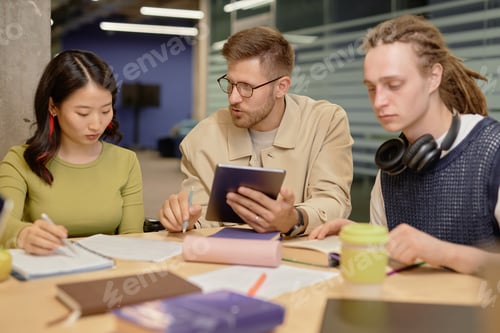 Preview: Male Teacher Helping Students with Task at Workshop