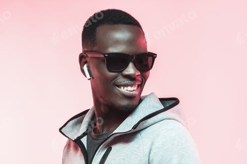 Preview: Young african american man listening music with earphones