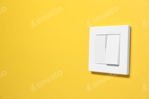 Preview: Modern plastic light switch on orange background. Space for text