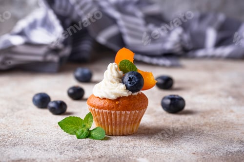 Preview: Delicious cupcake with fruit and cream topping