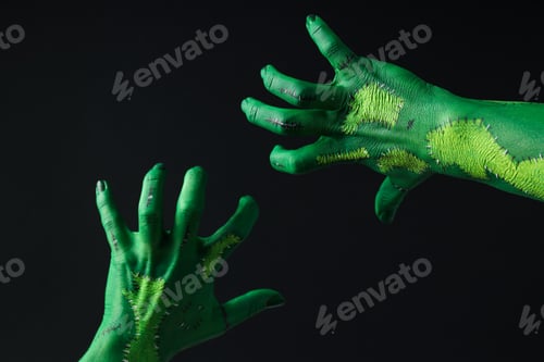 Preview: Green female hands on black background, close up