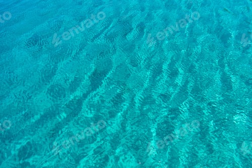 Preview: Sea surface turquoise blue color background, some reflections.