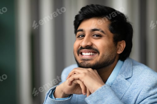 Preview: Closeup portrait of cheerful Indian entrepreneur man smiling at workplace