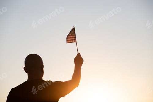 Preview: Man holding a waving american USA flag.